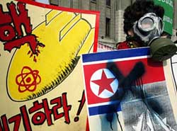 A South Korean protester holds a sign criticising North Korea