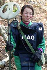 Cambodian Eng Sokay (25) smiles during a break in a minefield