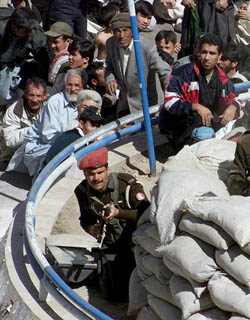 Pakistan Shia mourners take cover behind a para-military bunker after an attack on an Ashura procession in Baluchistans provincial city of Quetta on Tuesday. 