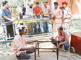 Students of Jan Shikshan Sansthan attend their class at Phase VI, Mohali, on Wednesday