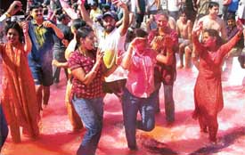 Youngsters play Holi at a resort near Panchkula on Saturday
