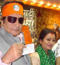Bollywood actor Manoj Kumar with TV personality Apra Mehta at the BJP headquarters in New Delhi on Monday.