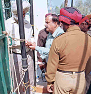 A contractor is frisked before being admitted to the excise auction in Patiala on Wednesday. 
