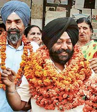 Mr Phulraj Singh (centre) in a jubilant mood after being elected senior vice-president of Municipal Council, Mohali, on Thursday. 