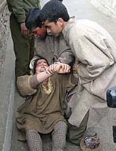 A woman wails after another woman, her relative, was killed in a crossfire