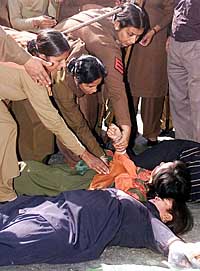 Policewomen try to detain women protestors during a demonstration in Jammu