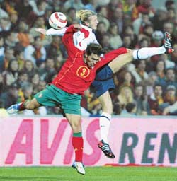 Englands David Beckham outjumps Portugals Rui Jorge during the international friendly match against England in Faro in February.