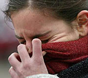A Spanish girl weeps outside Madrid's Santa Eugenia train station on Friday, the day after the series of explosions which left 198 dead and 1500 injured in the Spanish capital.