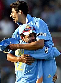 Yuvraj Singh hugs teammate Ashish Nehra following India's five-run victory over Pakistan 