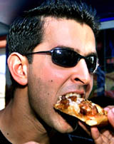 Bollywood star Hrithik Roshan enjoys a pizza during the launch of a new pizza outlet in Mumbai on Sunday.