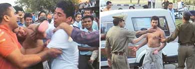 Harish Tanwar (bare-chested) pulls a punch at Lad Singh (in white T-shirt); and right policemen take away Harish from the battle ring at Panjab University Students Centre