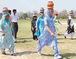 Senior citizens participate in chatti race at the Veterans Athletics Competition held at the Dasehra Grounds 
