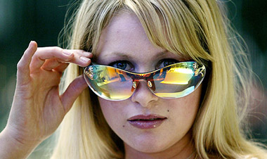 A model presents the Panasonic "Sunglass Terminal" prototype, glasses which create holographic pictures for the person wearing it