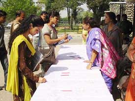 Activists of the Nari Jagran Manch launch a signature campaign in protest against the Womens Permanent Resident Status (Disqualification) Bill in Jammu on Monday.