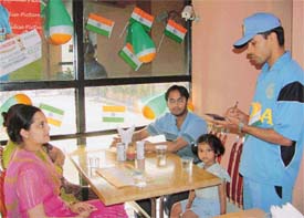 A waiter in the dress of the Indian cricket team at a restaurant in Ludhiana