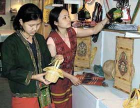 Exhibitors giving the final touches to their stall during the inauguration of the North East Trade Expo 2004 at Pragati Maidan in the Capital
