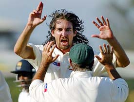 Australias Jason Gillespie runs to celebrate with his captain Ricky Ponting after he dismissed Sri Lankas Sanath Jayasuriya 