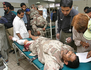 Pakistani doctors attend to a paramilitary soldier at a hospital in Karachi 