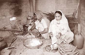 Women use the improved stove in Dhingsara village of Fatehabad district