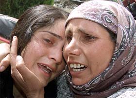 Kashmiri women wail as their house is destroyed in a gunbattle between security forces and militants in Narkora