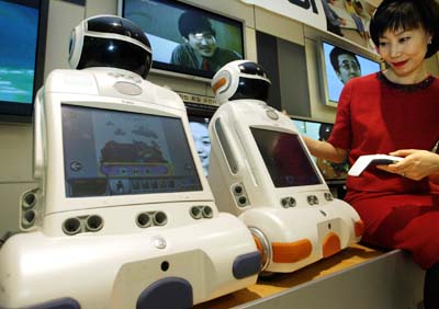 A promotional woman operates South Korea's intelligent robot 'Irobi' at a department store in Seoul.