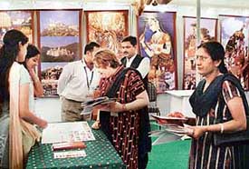 People inquire about best tourist destinations from the Rajasthan Tourism stall during the India Travel Mart exhibition at Hotel Shivalikview