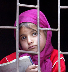 A Kashmiri girl watches the funeral of Ashiq Wani, a former political activist, in Srinagar on Monday. Wani (25) was killed by militants outside his house.