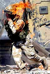 A British Army soldier runs in flames from a petrol bomb thrown during a violent protest by job seekers