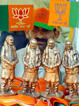 A shopkeeper displays statues of Prime Minister Atal Bihari Vajpayee in Bhopal 