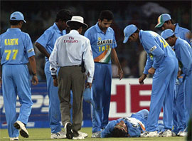 Indian players along with the umpire attend captain Sourav Ganguly 