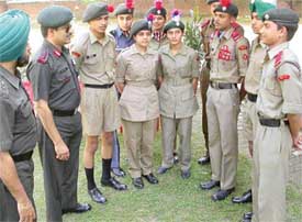 NCC Group Commander, Col Ashwini Sharma (second from left) interacts with cadets who were honoured for excellence in training in Chandigarh on Thursday.