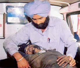 The injured labourer, Channu, being taken to hospital in an ambulance