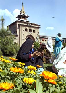Kashmiri Muslim women pray in front of the 600-year-old grand mosque