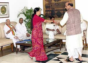 Union Agriculture Minister Rajnath Singh with Rajasthan Chief Minister Vasundhra Raje before the BJP Central Election Committee meeting at the Prime Minister's residence in New Delhi on Saturday. 