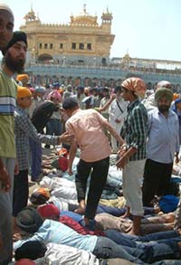 Kar sevaks facilitate the movement of devotees, especially the aged, women and children, by making a human path in the de-silted sarovar of the Golden Temple in Amritsar on Sunday. 