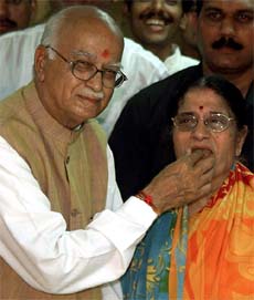 Deputy Prime Minister L. K. Advani offers sweets to his wife Kamala Advani after filing his nomination for the Gandhinagar Lok Sabha seat 