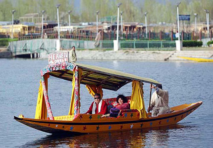 A tourist couple enjoy a Shikara ride in Dal Lake in Srinagar 