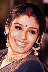 Bollywood actress Raveena Tandon smiles during a news conference to promote her latest TV serial Saheb Biwi Aur Gulam 