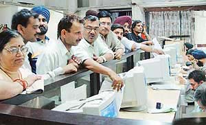 A heavy rush of depositors outside the Sector 17 Treasury Branch of the State Bank of India, Sector 17, at 10 pm as they come to deposit cash on the closing day of the financial year.