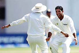 Yuvraj Singh being congratulated by teammate Virender Sehwag after he took the wicket of Pakistan's Yaseer Hameed