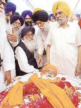 The Akali Dal President, Mr Parkash Singh Badal, and other party leaders, Capt Kanwaljit Singh, Mr Prem S. Chandumajra, Mr Charanjit Singh Walia and Mr Harmel Singh, sit beside the body of SGPC chief Gurcharan Singh Tohra at his home in Tohra village in Patiala