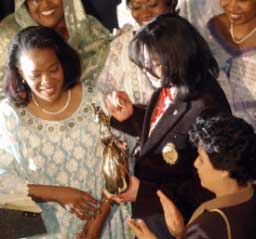 Michael Jackson receives a humanitarian award from Haoua Diatta, wife of the Nigerian Ambassador, during the annual African Ambasadors Spouses Association function at the Ethiopian Embassy in Washington on Thursday. 
