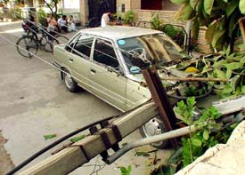 The car that survived Scud missiles during the 1991 Gulf War passing through several countries beneath an electricity pole which fell on it on Sunday