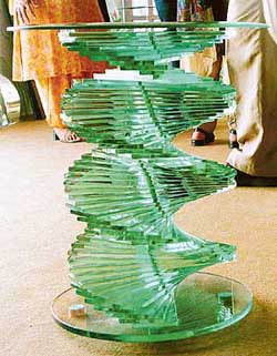 A funky glass bar table adds a dash of elegance and brightness to the room