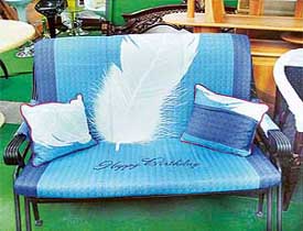 A wrought iron couch with a "feathery" upholstery