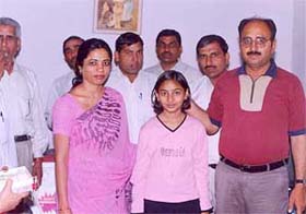 Jyoti who topped in 8th class exams conducted by the HSEB, along with her relatives and members of the school management