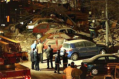 Spanish police and rescue workers inspect the scene of an explosion in a Madrid suburb on Saturday