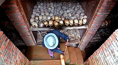 A worker cleans a mass grave outside a church in Nyanza, Rwanda, on Sunday