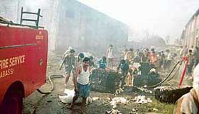 Employees and fireman extinguish fire that broke out at a yarn spinning unit on the Dera Bassi-Barwala road in Bhagwanpur village, near Dera Bassi, on Monday afternoon. 