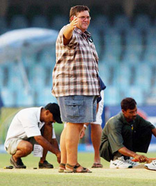 English pitch curator Andy Atkinson inspects the pitch after the first day's play in Lahore 